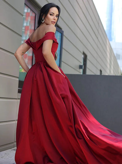 Side view of a woman wearing the satin off-the-shoulder A-line dress.