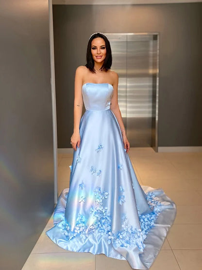 Front view of an A-Line satin strapless prom dress with hand-made flowers.