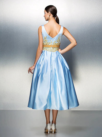 Back view of A-line satin dress showing V-back and pleats.
