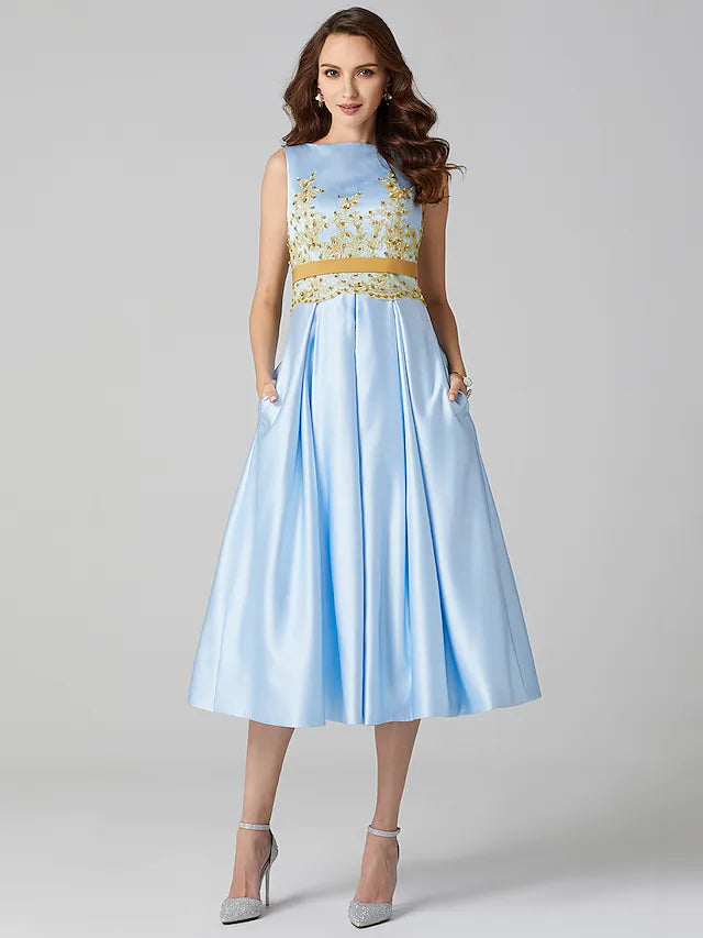 Close-up of the A-line dress fabric, pleats, and appliques.