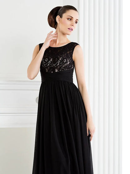 Side view of a woman in a formal A-line lace gown.