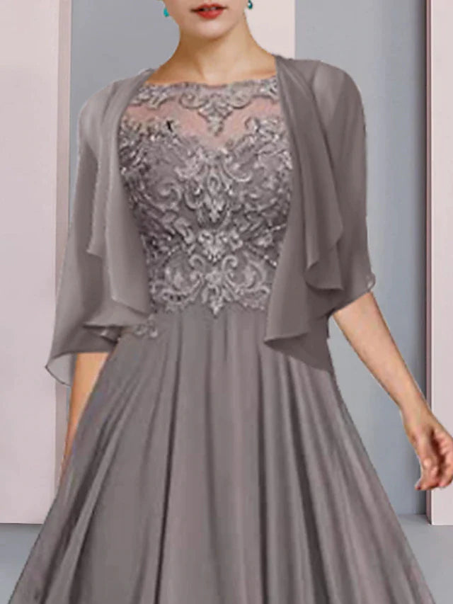 Woman in an elegant A-line mother of the bride dress with half sleeves and a scoop neck, side view.