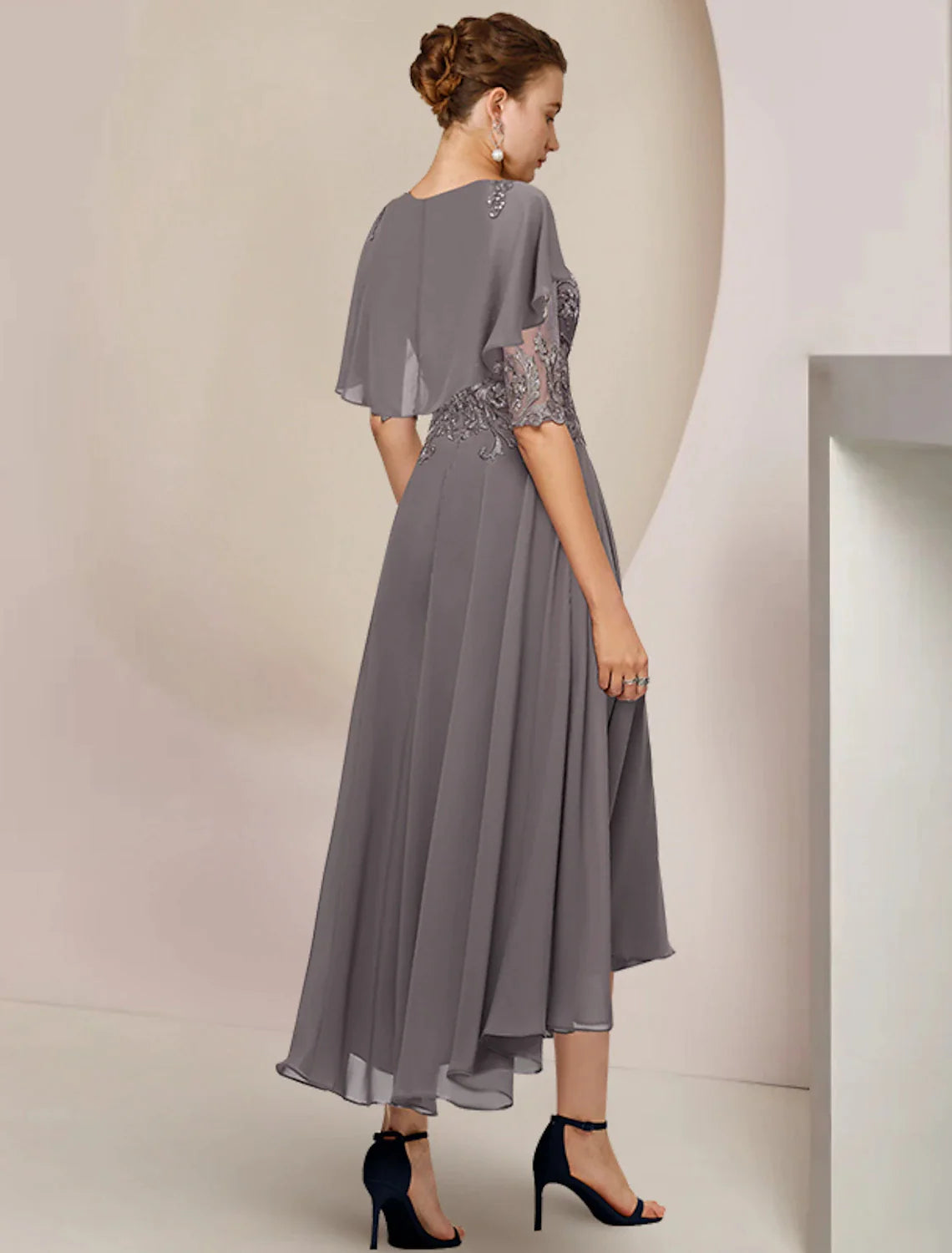 Formal tea-length chiffon lace dress with beading appliques, side view.