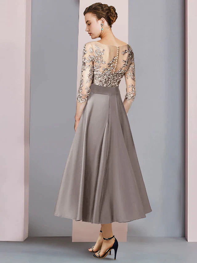Side view of the tea length satin and lace dress with bow appliques.