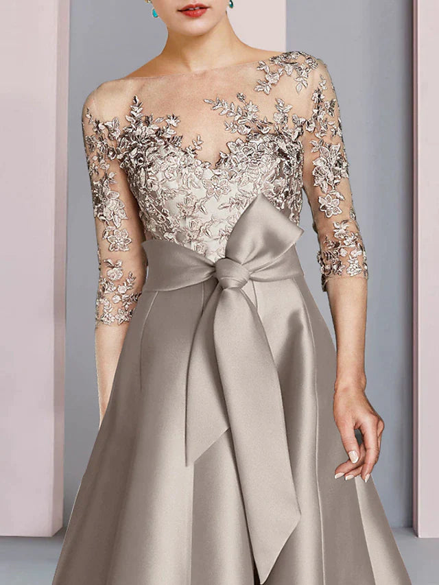 Model showcasing the elegant tea length dress, highlighting the half sleeves.