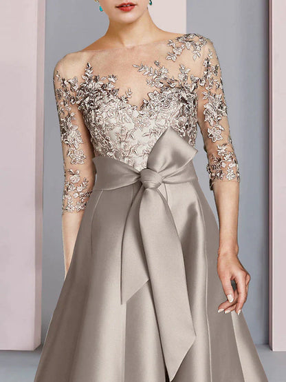 Model showcasing the elegant tea length dress, highlighting the half sleeves.