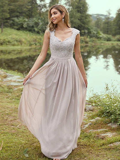 Front view of an elegant A-line chiffon bridesmaid dress with scoop neck, short sleeves, and delicate applique.