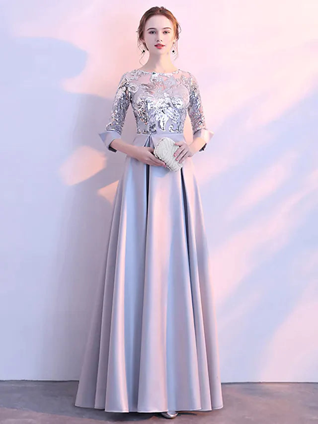 Close-up of the sequin embellishments and 3/4 sleeves on the formal dress.