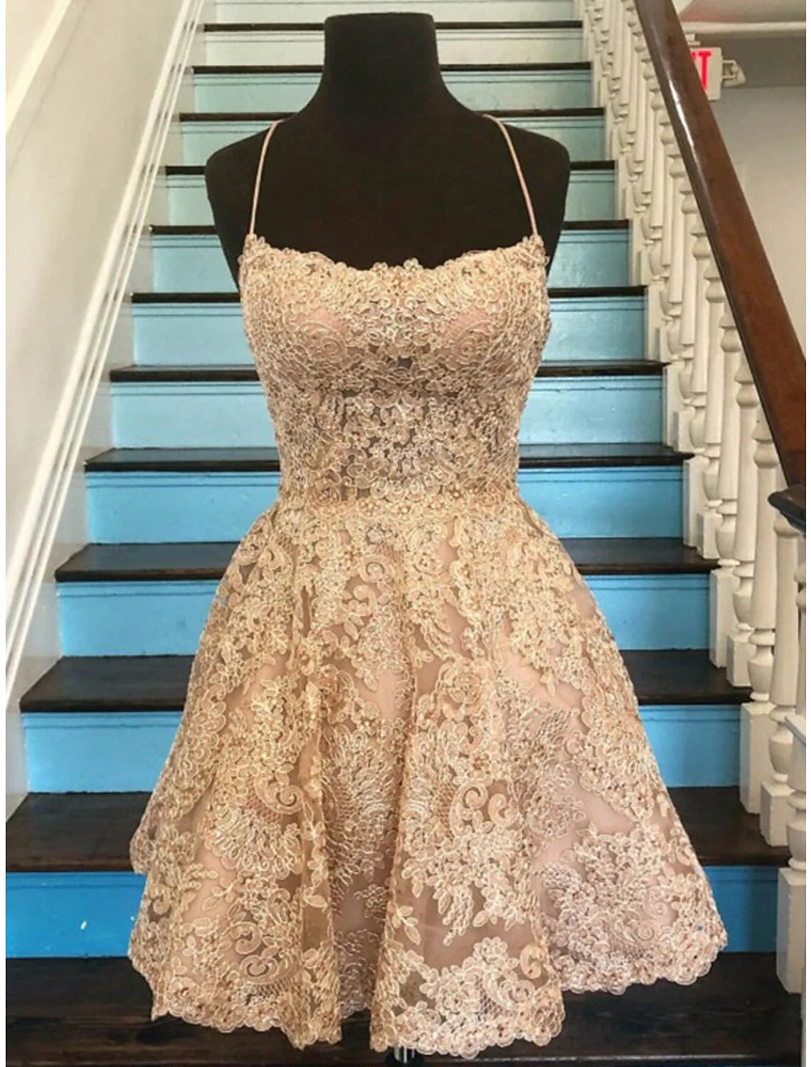 Back view of the A-line short spaghetti strap dress with floral details.