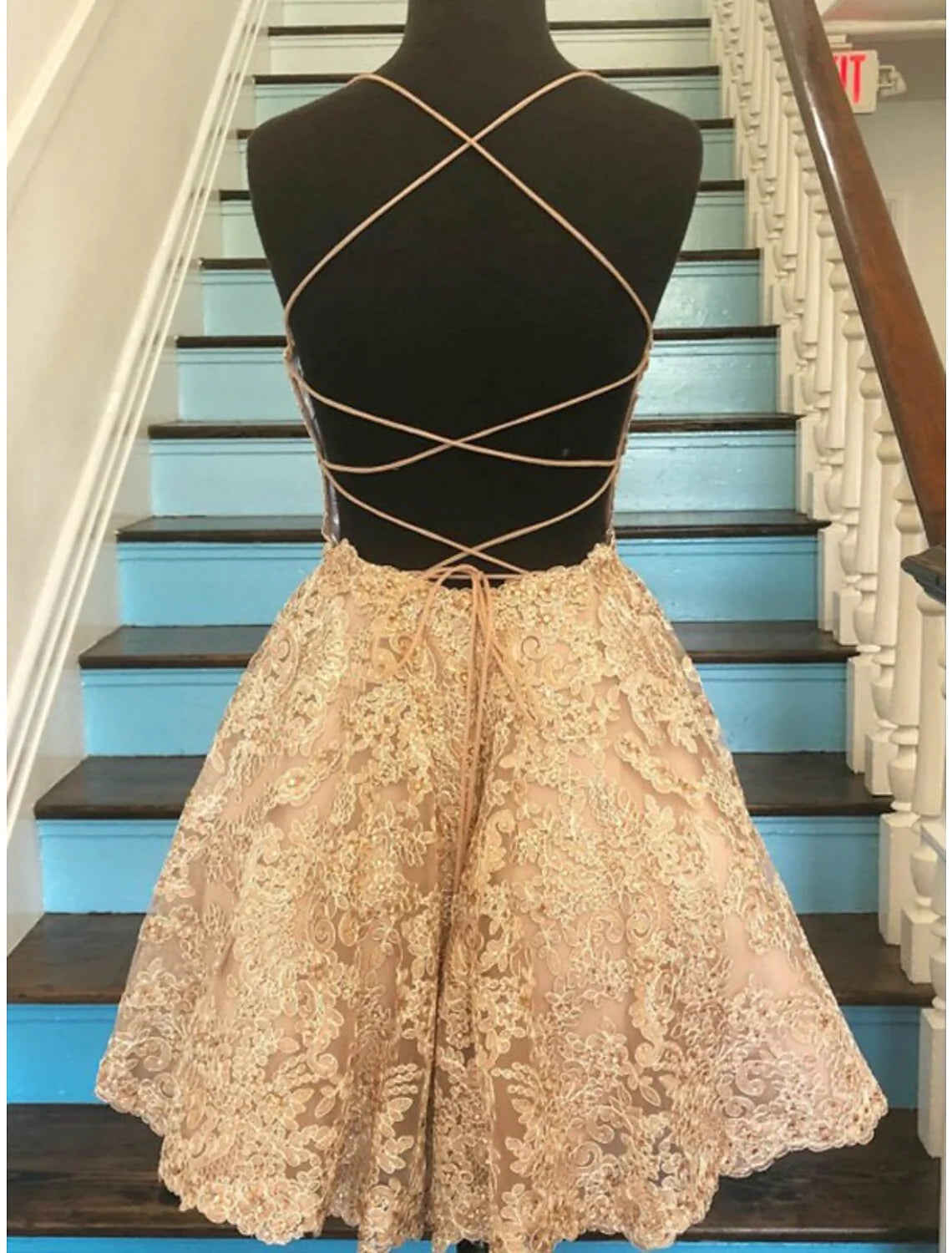 Side profile of a model showcasing the floral lace homecoming dress.