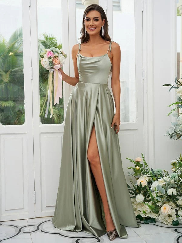 A woman in a light-colored A-line bridesmaid dress with ruffles and spaghetti straps, viewed from the front.
