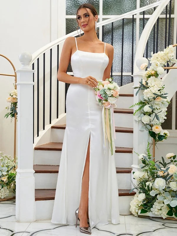 Elegant A-line bridesmaid dress with ruffles and spaghetti straps, shown from the side.