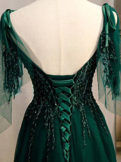 Back view of the A-line formal evening dress, showcasing the sweep train and intricate beading.