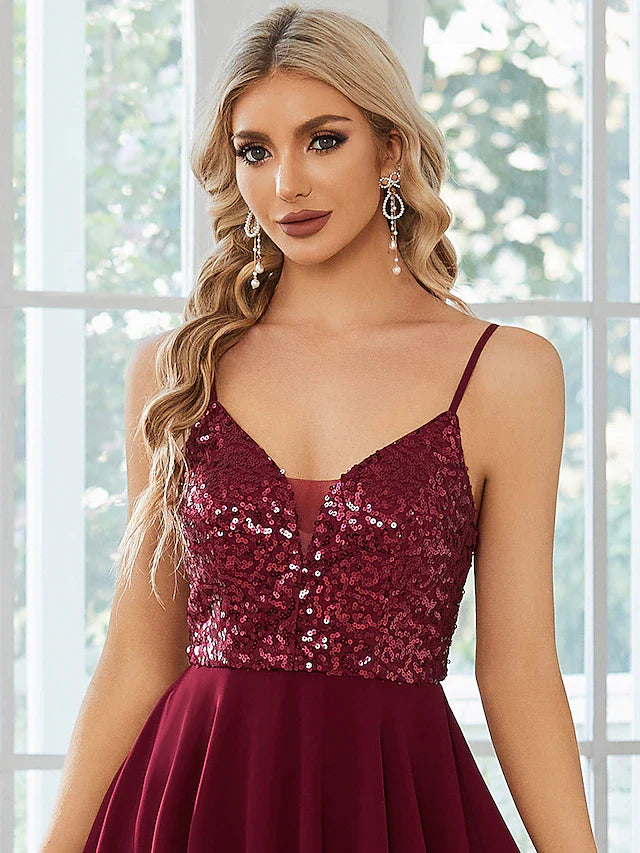 Full length view of a model posing in the short sequin homecoming dress.