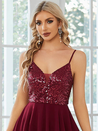 Full length view of a model posing in the short sequin homecoming dress.