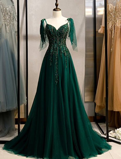 Elegant A-Line spaghetti strap evening dress with intricate beading and a sweep train.
