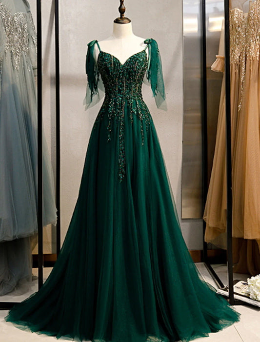 Elegant A-Line spaghetti strap evening dress with intricate beading and a sweep train.