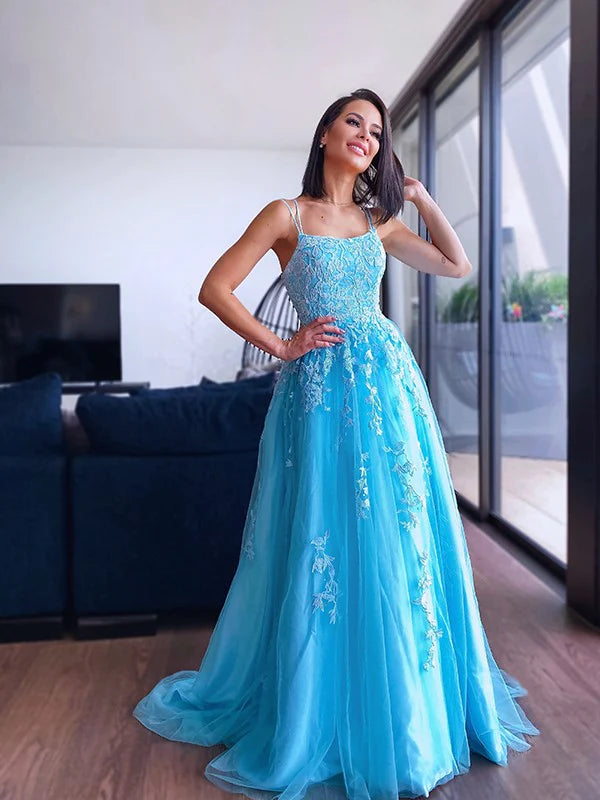 Close-up of the bodice of the light blue prom dress, showing applique and spaghetti straps.