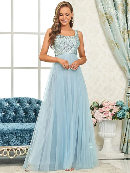 Back view of a woman in a floor-length sequined bridesmaid dress, highlighting the delicate straps.
