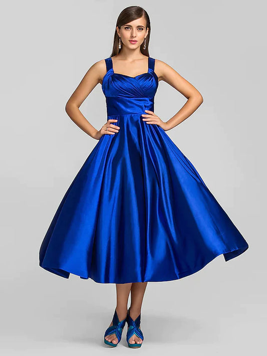 Woman wearing an elegant dark A-line square neck tea length dress.