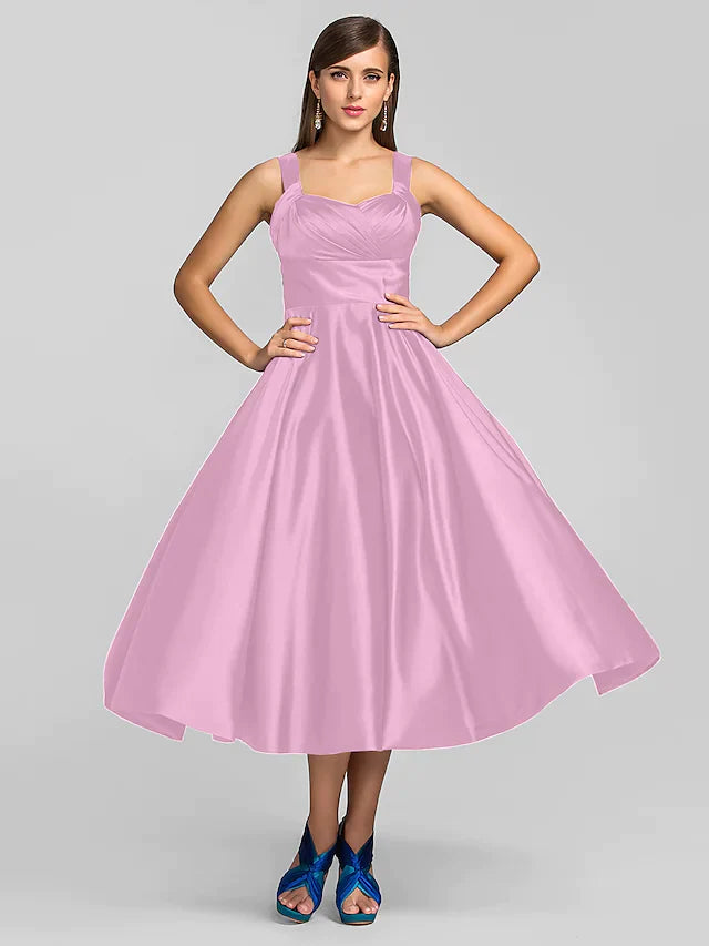 Woman walking in a sophisticated square neck tea length dress.