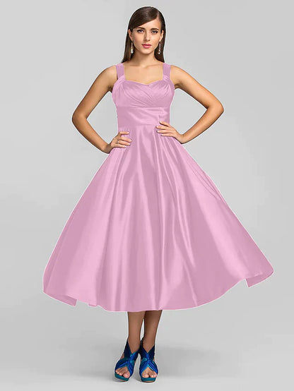 Woman walking in a sophisticated square neck tea length dress.