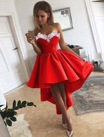 Model wearing an elegant A-line strapless satin cocktail dress with appliques.