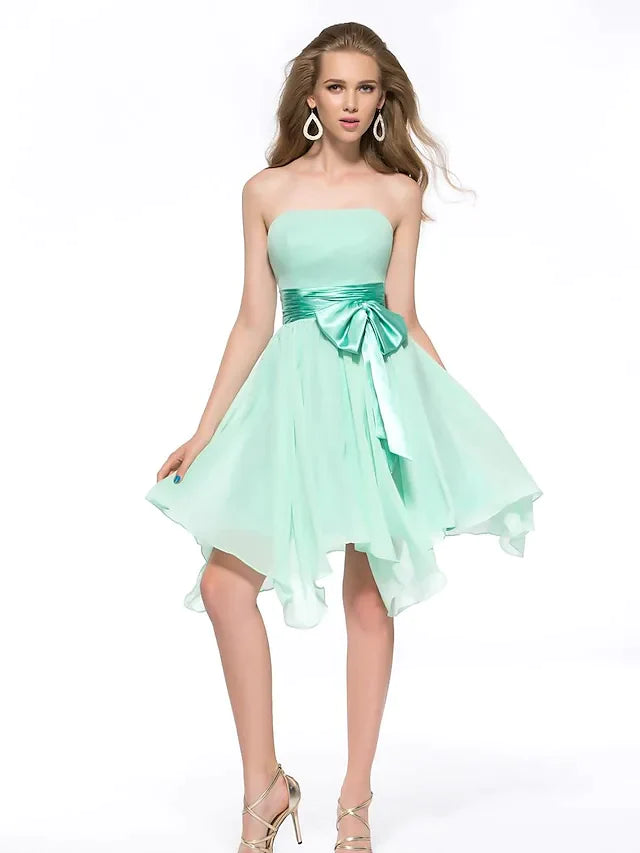 Elegant strapless A-line chiffon dress with asymmetrical hem and sash.
