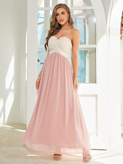 Woman wearing an elegant A-line floral chiffon dress with delicate appliques.
