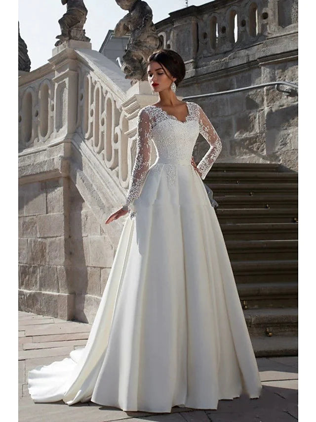 Elegant A-line strapless wedding dress with lace appliques and a flowing court train.