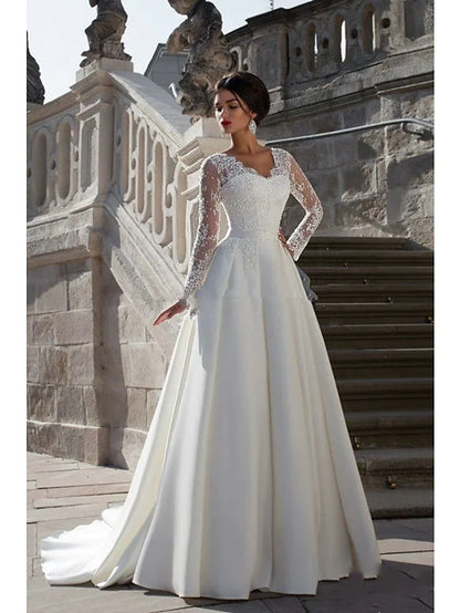 Elegant A-line strapless wedding dress with lace appliques and a flowing court train.