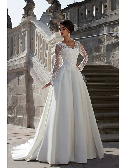 Elegant A-line strapless wedding dress with lace appliques and a flowing court train.