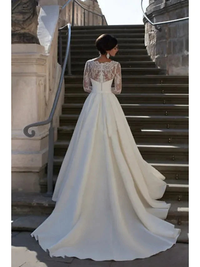 Close-up of the strapless bodice and lace appliques on an A-line wedding gown.