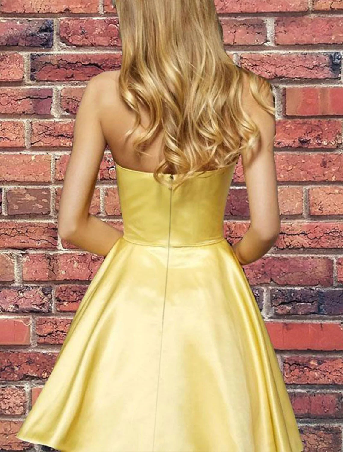 Back view of a woman in a strapless A-Line satin cocktail dress.