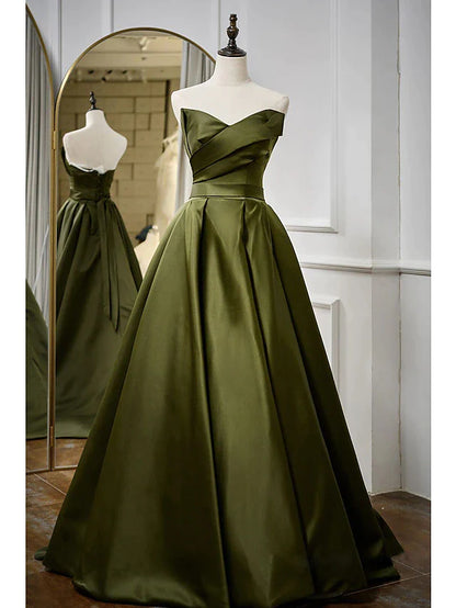 Woman wearing an elegant A-line strapless satin floor-length evening gown.