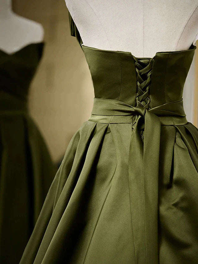 Close-up of the pleated bodice on an A-line strapless satin evening gown.