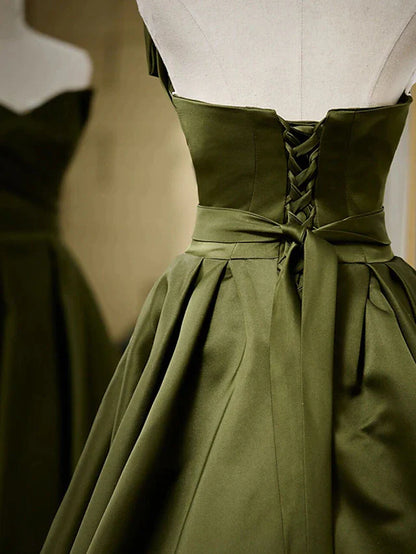Close-up of the pleated bodice on an A-line strapless satin evening gown.