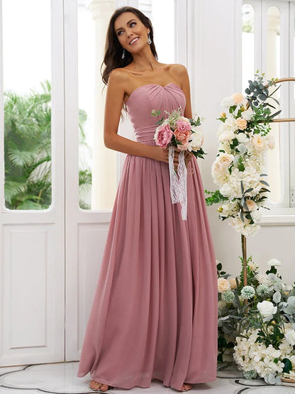 Back view of a floor-length A-line light blue bridesmaid dress with flowing chiffon skirt.
