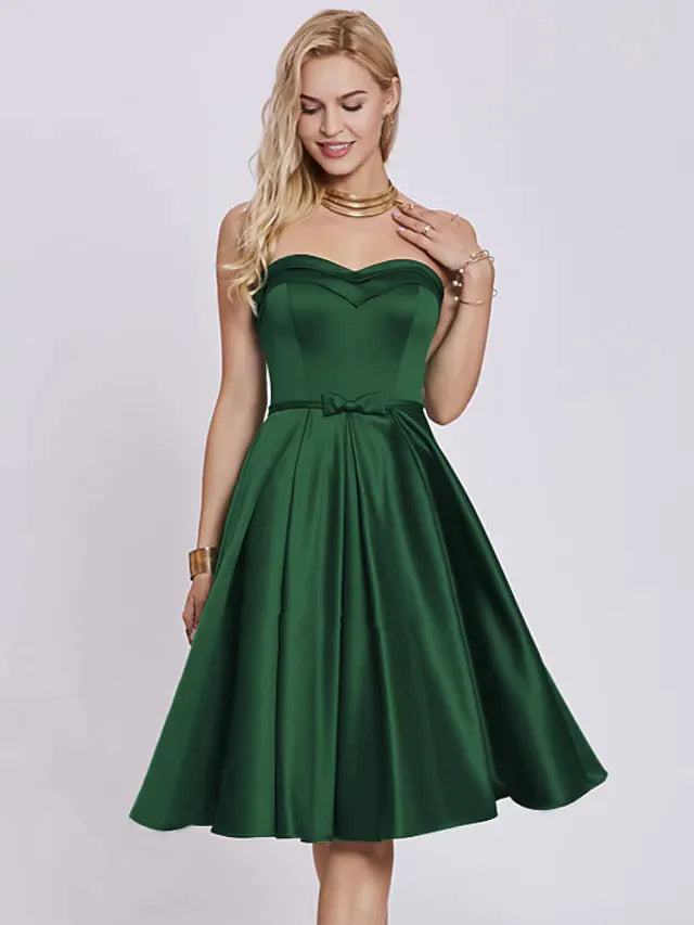 Elegant A-line strapless satin cocktail dress with pleats and a bow.