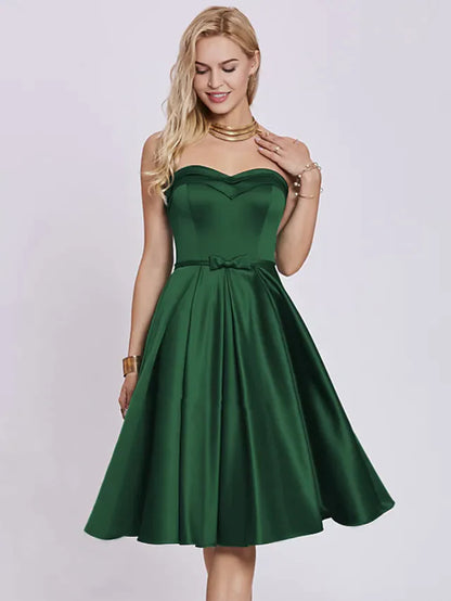 Elegant A-line strapless satin cocktail dress with pleats and a bow.