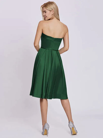 Back view of a strapless A-line satin dress featuring a large bow detail.