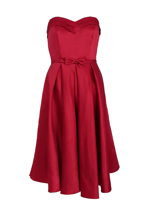 Woman posing gracefully in a strapless A-line satin engagement dress.