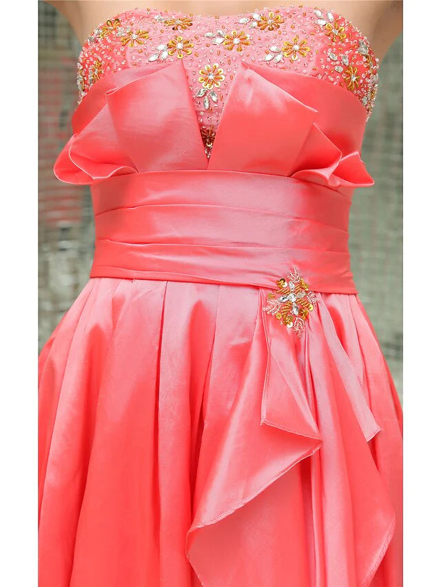 Close-up of the pleated and beaded details on an A-line strapless short mini taffeta cocktail dress.