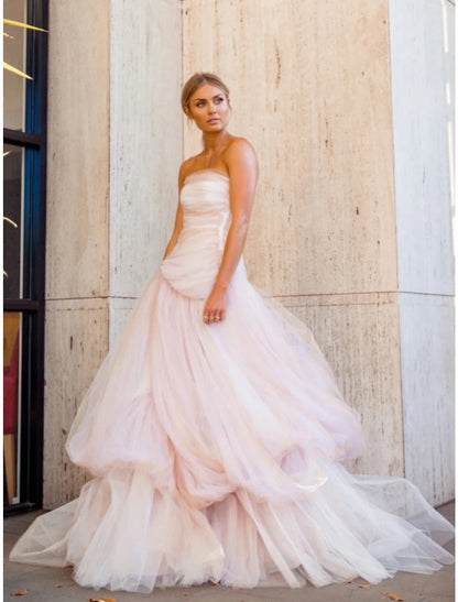 Full-length view of an elegant A-line strapless tulle evening gown with pleats and ruched details, featuring a court train.