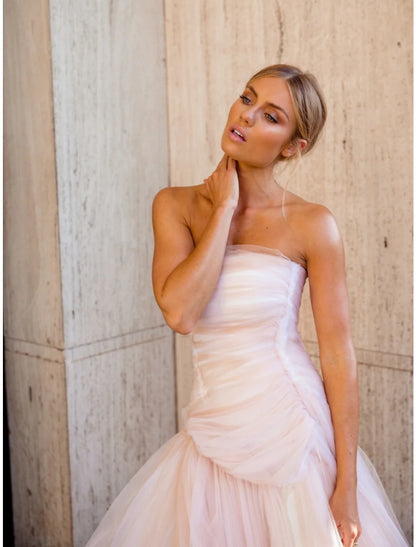 Back view of the elegant strapless tulle gown, showing the court train and delicate fabric.