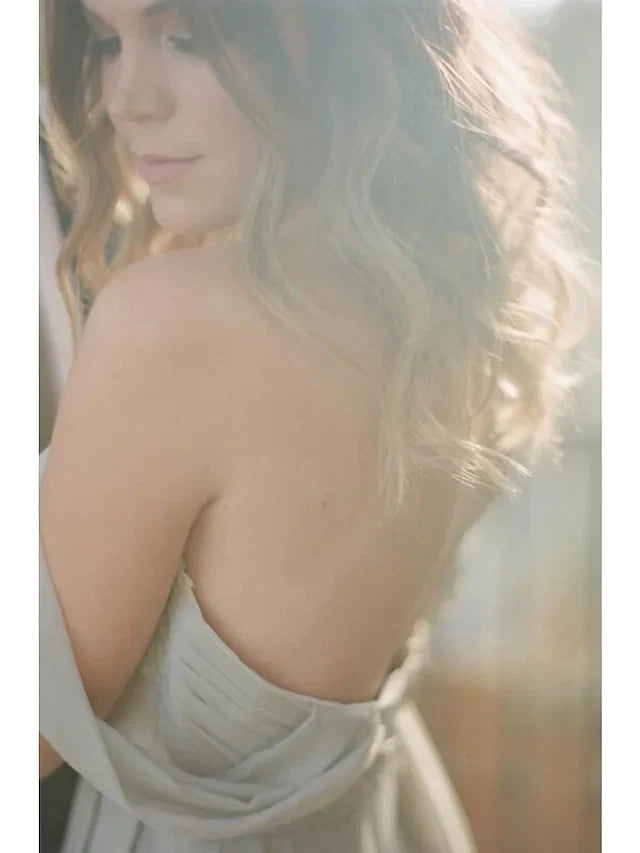 Back view of a woman in a floor-length A-line chiffon bridesmaid dress.
