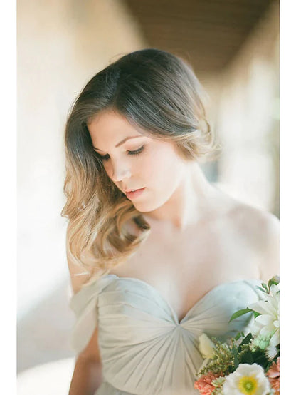 Close-up of the sweetheart neckline and pleated bodice of the chiffon bridesmaid dress.