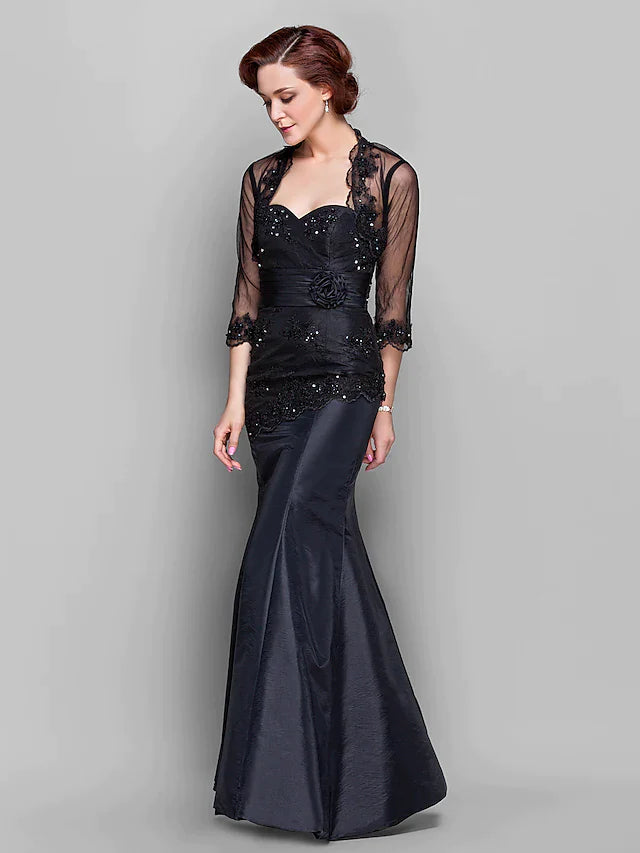 Back view of the elegant floor-length Mother of the Bride dress, showcasing ruched details and flowing taffeta tulle skirt.