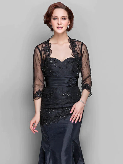 Side view of a woman in the Mother of the Bride dress, highlighting the A-line silhouette and long sleeves.
