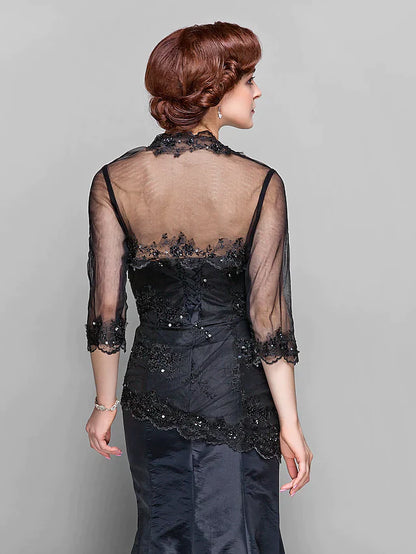 Detail shot of the intricate lace and beading on the long sleeve of the Mother of the Bride dress.